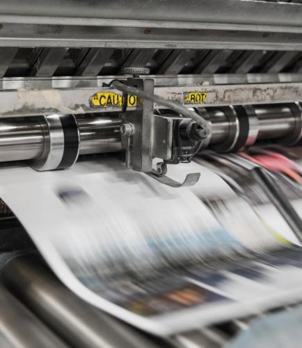 Paper going through a printing press