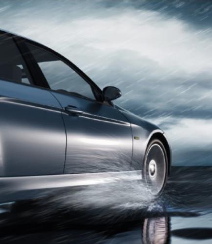 Car driving on wet pavement